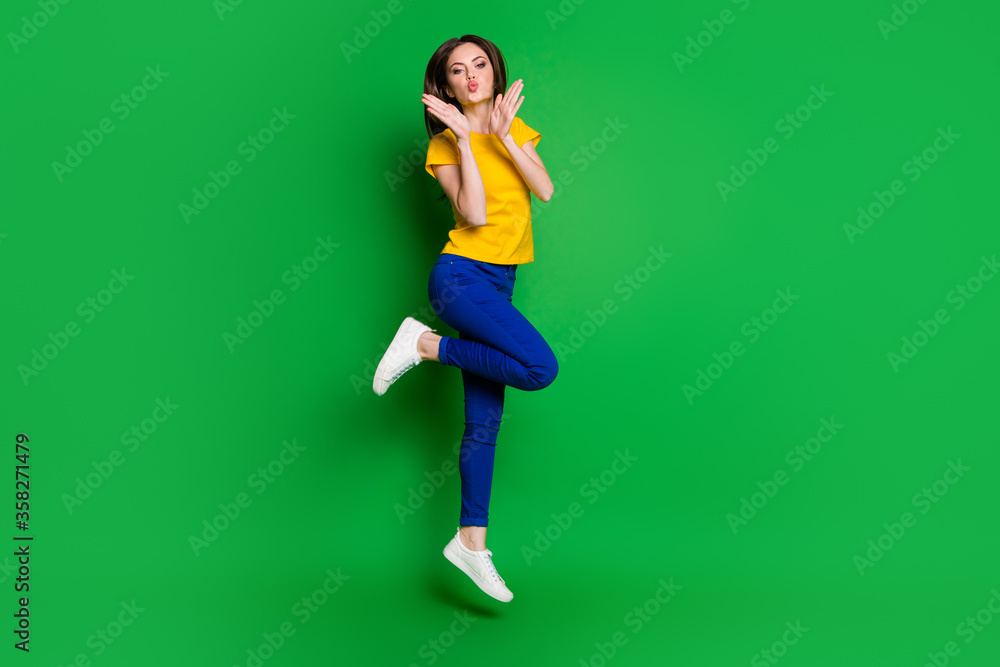 Full length body size view of her she nice attractive lovely lovable funky cheery slim fit girl jumping having fun sending air kiss isolated bright vivid shine vibrant green color background Full length body size view of her she nice attractive lovely lovable funky cheery slim fit girl jumping having fun sending air kiss isolated bright vivid shine vibrant green color background