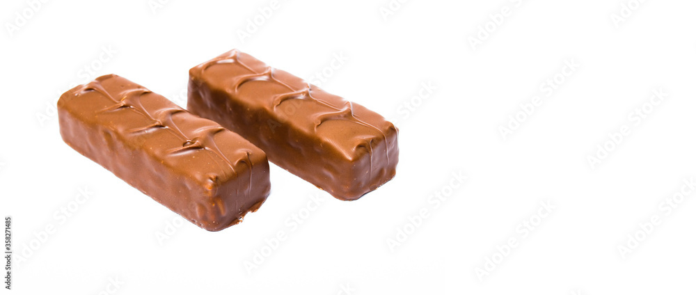 Two small snickers bars weighing 50 grams without packaging in macro are lying next to each other. Snickers two sticks, chocolates Two small snickers bars weighing 50 grams without packaging in macro are lying next to each other. Snickers two sticks, chocolates