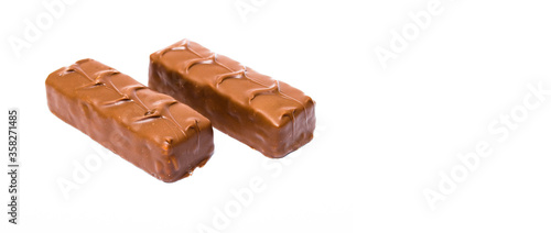 Two small snickers bars weighing 50 grams without packaging in macro are lying next to each other. Snickers two sticks, chocolates