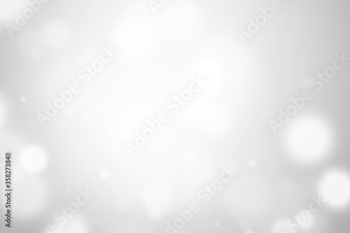 Bokeh abstract blurred silver and white beautiful background. Soft color light glitter sparkles. element for backdrop or design cosmetic ads, winter, christmas, luxury, beauty, baby, modern, creative