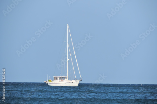    white sailing boat drifts into the sea    © ElenaEmiliya