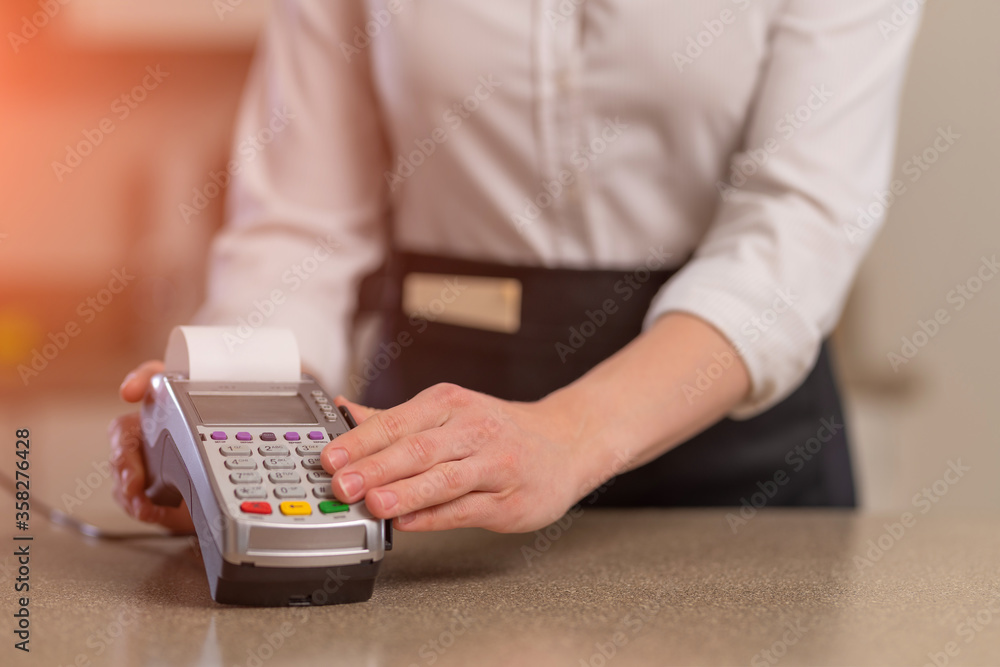 The waiter accepts payment through the terminal, non-cash payment. Restaurant business The waiter accepts payment through the terminal, non-cash payment. Restaurant business