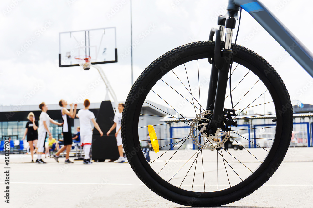 Bicycle wheel on the background of a basketball court. Bicycle wheel on the background of a basketball court.