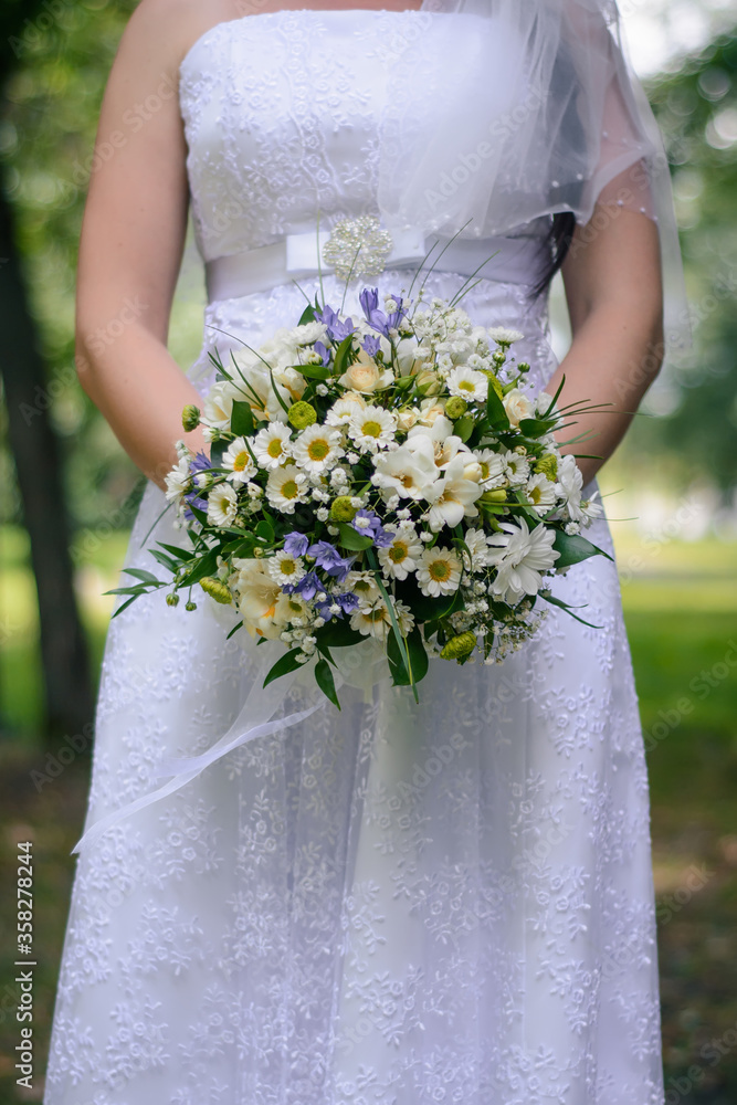wedding flower bouquet in the hands of the bride wedding flower bouquet in the hands of the bride