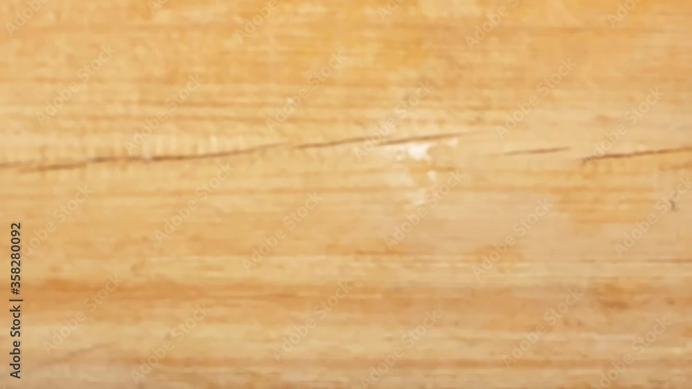 Slow motion of man taking glass of orange juice on wooden surface Slow motion of man taking glass of orange juice on wooden surface