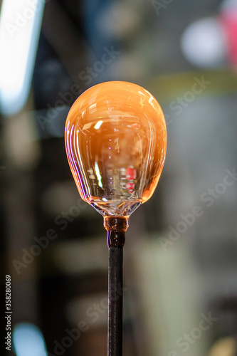 Obraz na plátně Vertical close-up picture of a shaped molten piece of glass extracted from the furnace located in a glass factory in Romania where each piece is manually made by the glassblower artisans