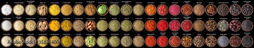 large set of Indian spices and herbs isolated on  black background. Colorful seasoning for spicing food photo