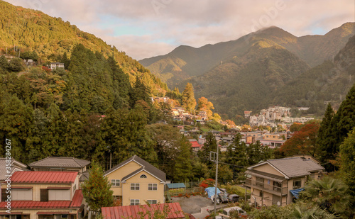 Small Japanese mountain town stretched along a valley on an autumn morning