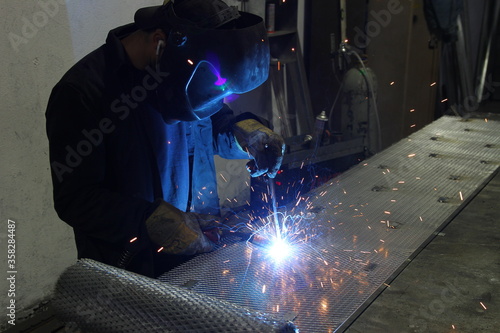 worker welding metal