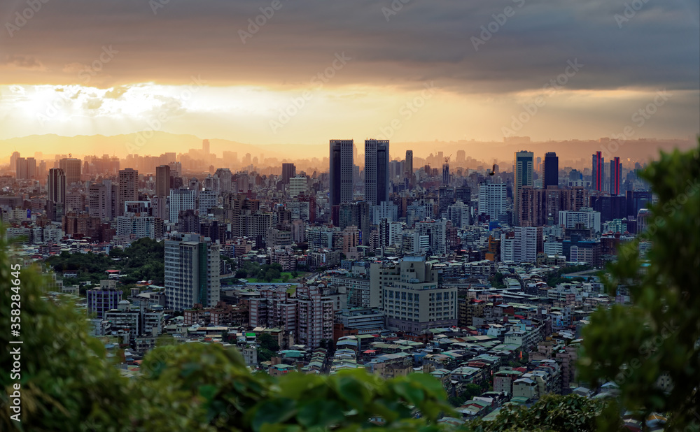 Dark Taipei cityscape viewed from a nearby mountain in the late afternoon