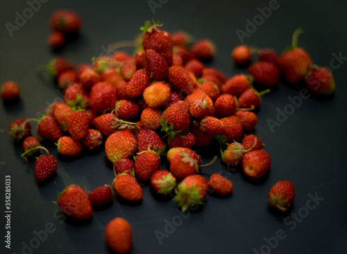 many berries on the table. Strawberry