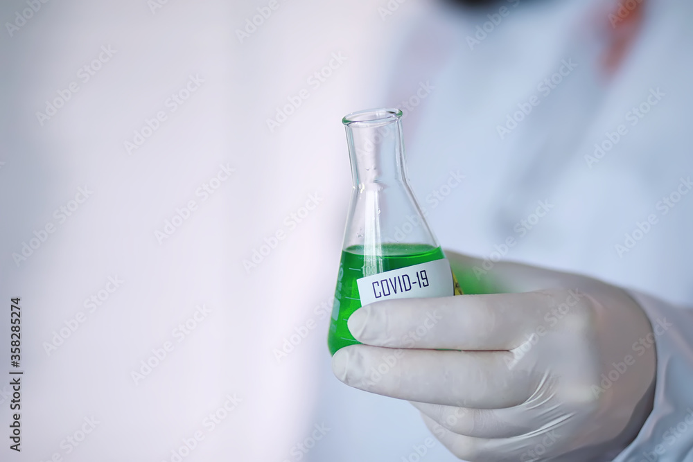 A scientist researcher in the laboratory is testing drugs for the treatment of viral pneumonia. Coronovirus blood test of infected patients. World pandemic. A scientist researcher in the laboratory is testing drugs for the treatment of viral pneumonia. Coronovirus blood test of infected patients. World pandemic.