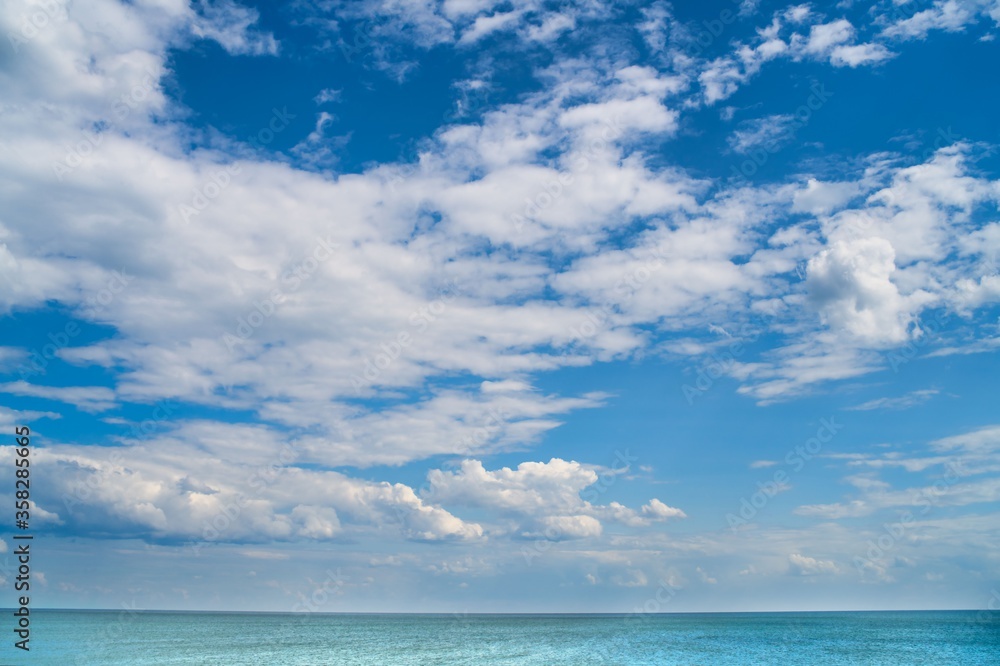 white clouds floating in the blue sky