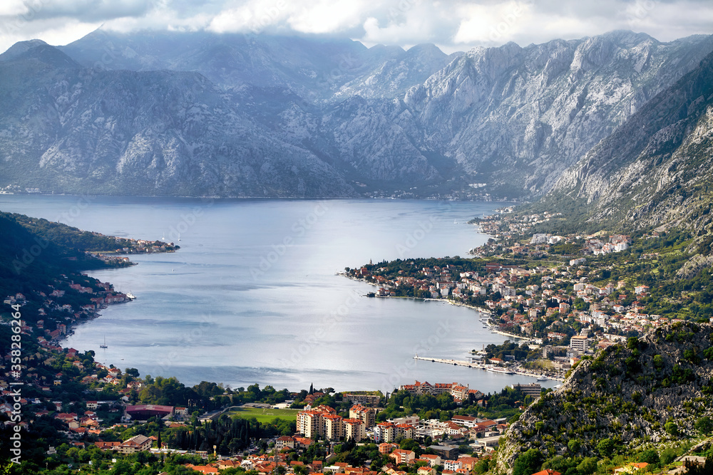 Montenegro Kotor Bay panorama famous Adriatic sea fjord mountains town travel tourism destination old city architecture cityscape harbor mediterranean aerial view. Bright clouds sunny summer day