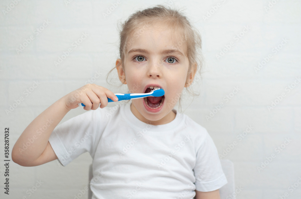 Little girl holds a toothbrush in her hands and toothpaste brushes Little girl holds a toothbrush in her hands and toothpaste brushes