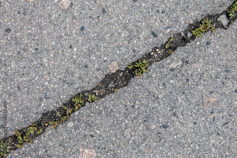 Background and texture of pavement with cracks close up. A symbol of trouble and problems in the relationships Background and texture of pavement with cracks close up. A symbol of trouble and problems in the relationships