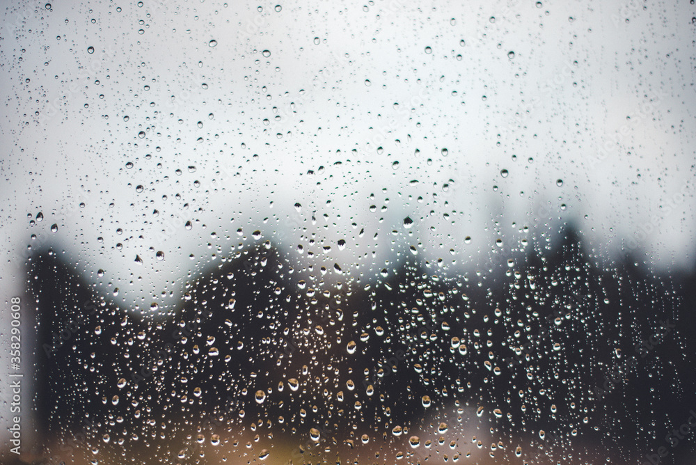 raindrops flowing down the window. The concept of sadness and grief raindrops flowing down the window. The concept of sadness and grief