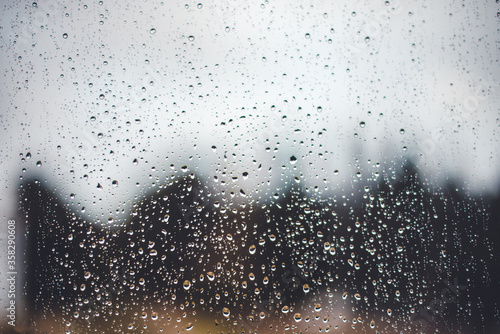 raindrops flowing down the window. The concept of sadness and grief
