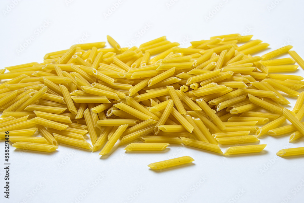 heap of pasta on a white background. raw pasta in a pile heap of pasta on a white background. raw pasta in a pile
