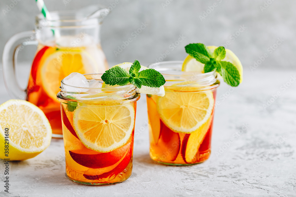Cold peach and lemon iced tea. Summer refreshing drink Cold peach and lemon iced tea. Summer refreshing drink