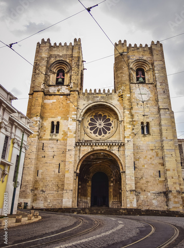road and path for the subway and a large cathedral with two towers. The main entrance. Cathedral in Lisbon