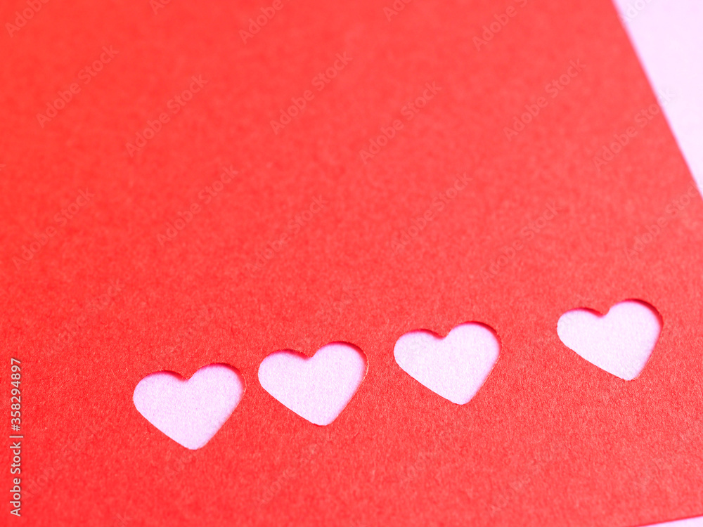 Red paper, punching in a heart shape, placed on pink paper for the background of your text. The concept for design, wallpaper, love . Red paper, punching in a heart shape, placed on pink paper for the background of your text. The concept for design, wallpaper, love .