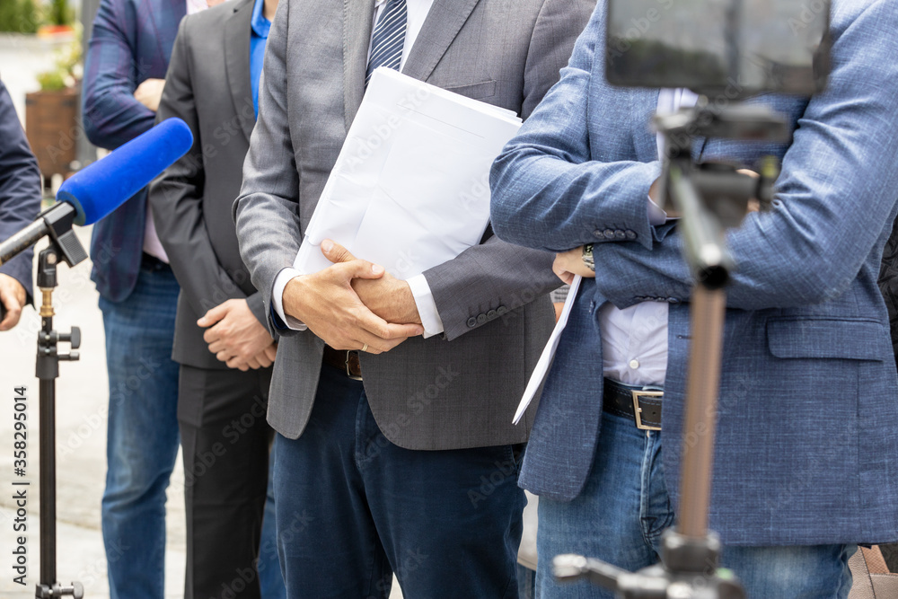 Fototapeta premium Lawyer or attorney holding documents, giving statement at news conference