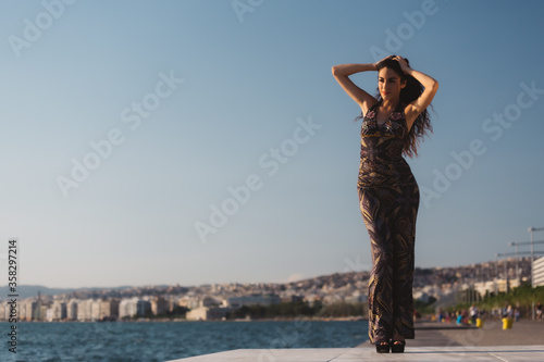 Girl in a long dress on the background of the promenade © olgalisa88
