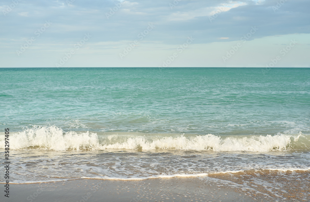 Sea waves on the beach at sunset Sea waves on the beach at sunset