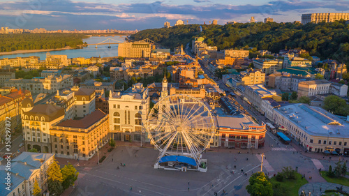 Beautiful summer evening sunset light in Kyiv   Kiev  Ukraine. Podil area Postal Square Ferris wheel and Sahaidachnoho Street. Aerial drone top panoramic view from above.  European capital destination