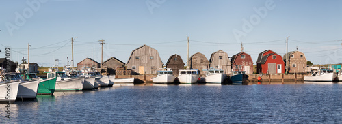 Panorama of a row of Oyster barns and fishing boats at Malpeque Harbour photo