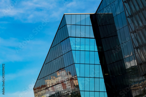 Fragment of the facade of the office building against the blue sky.