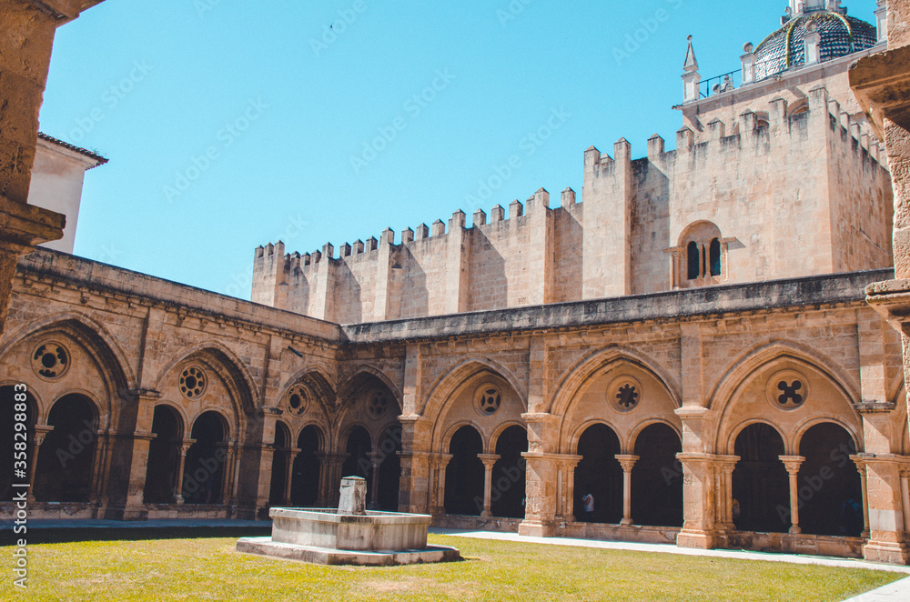 the wall of the monastery with interesting arches. Large cathedral with a garden