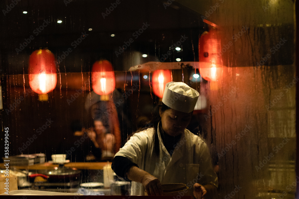 Lady working in a Chinese restaurant