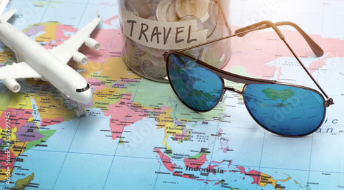 plan to travel with sunglasses on world map photo