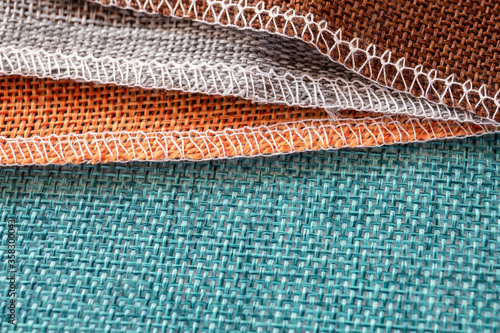 Gray, orange, green and brown textiles. Fabric for decoration, embroidery