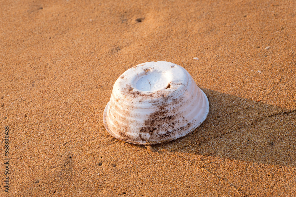 Garbage on the beach That come from tourists and fishmen, plastic waste, form cup and rope on the beach.Styrofoam cup on tropical beach pollutes the sea and marine life. Garbage on the beach That come from tourists and fishmen, plastic waste, form cup and rope on the beach.Styrofoam cup on tropical beach pollutes the sea and marine life.