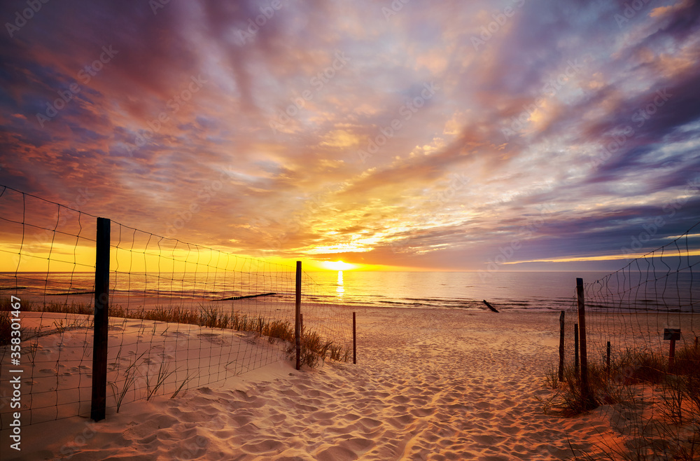 Scenic sunset over Baltic Sea beach with dramatic cloudscape, Poland. Scenic sunset over Baltic Sea beach with dramatic cloudscape, Poland.
