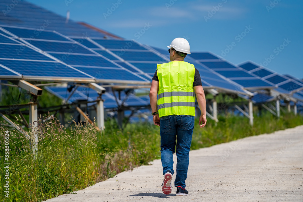 Expertise service worker on measuring efficiency of operation and maintenance at solar plant.
