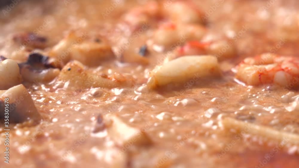 Detail of a paella of rice with prawns being cooked Detail of a paella of rice with prawns being cooked