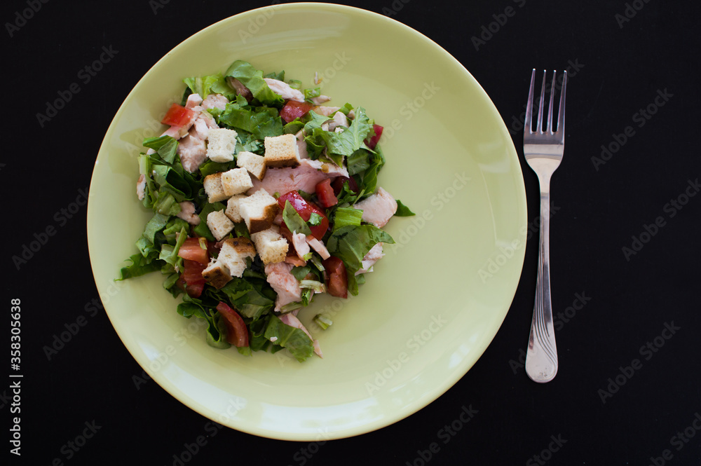 Top view image of Caesar chicken salad isolated on black background. Top view image of Caesar chicken salad isolated on black background.