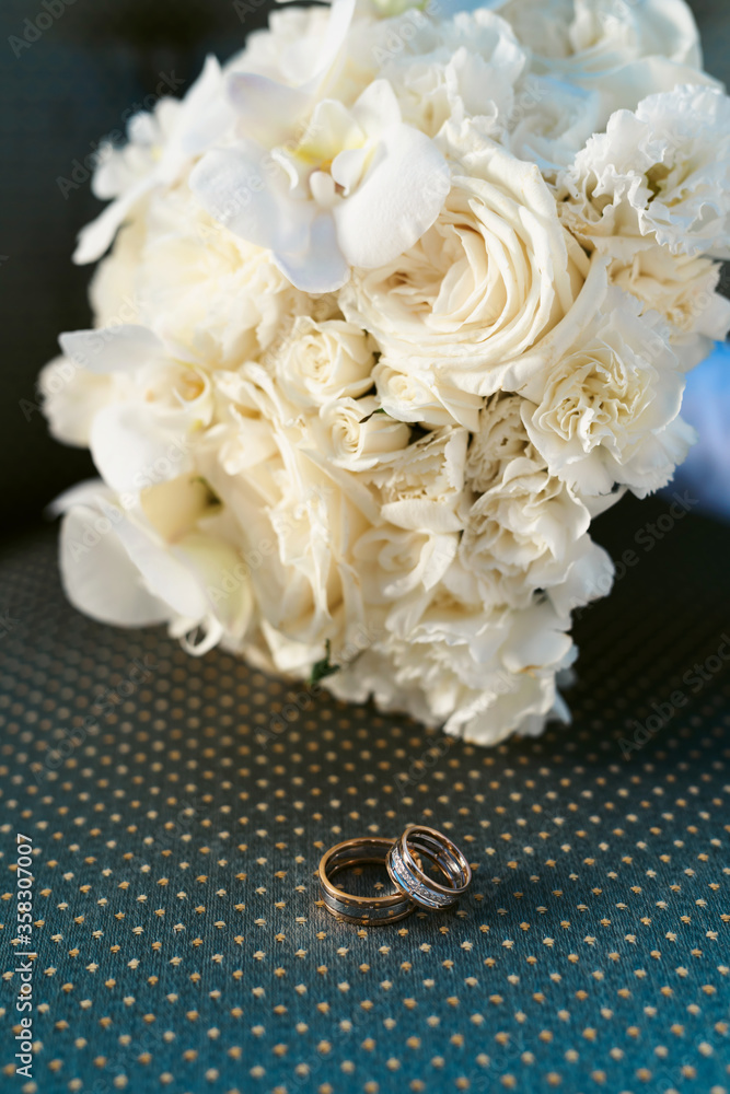 Elegant wedding accessories of an attractive bride. Wedding rings, shoes, bridal bouquet, floral arrangements, veil. Copy space for text. Background for greeting card or invitation. Elegant wedding accessories of an attractive bride. Wedding rings, shoes, bridal bouquet, floral arrangements, veil. Copy space for text. Background for greeting card or invitation.