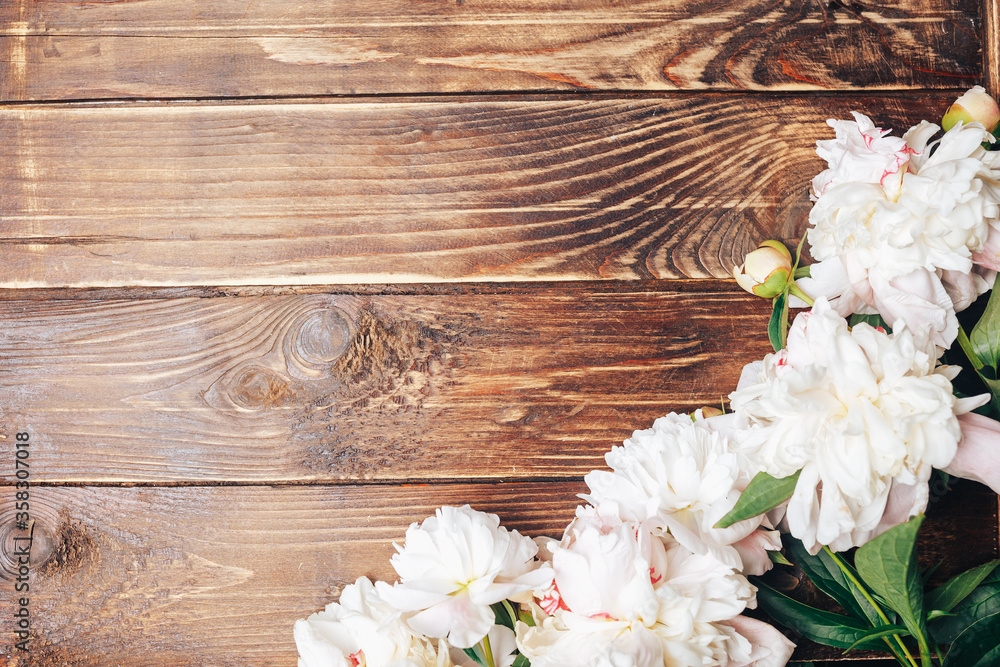 Beautiful delicate peonies on a wood background, blooming flowers, March 8, Mom s day, birthday gift Beautiful delicate peonies on a wood background, blooming flowers, March 8, Mom s day, birthday gift