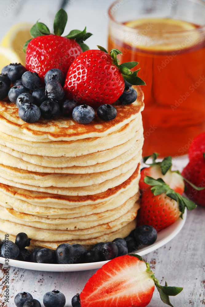 A stack if home-made pancakes with berry A stack if home-made pancakes with berry