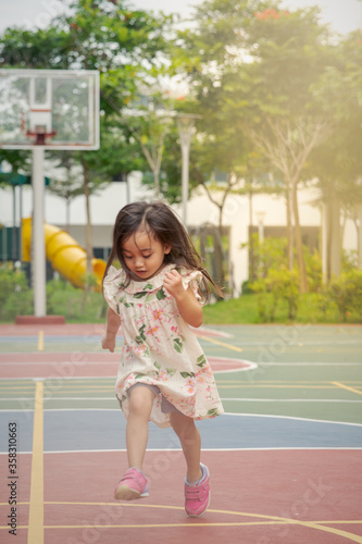 Happy Asian toddler in the park. © ellinnur