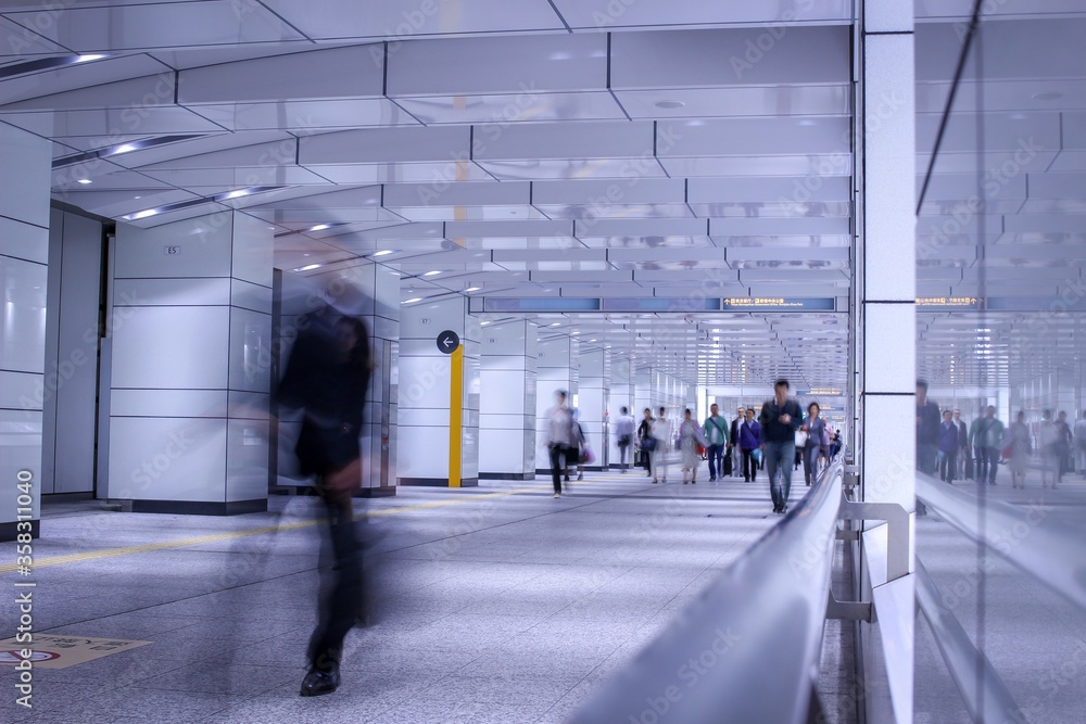 Blurred people walking through and underground passage in Tokyo. Taken with slow shutter speed