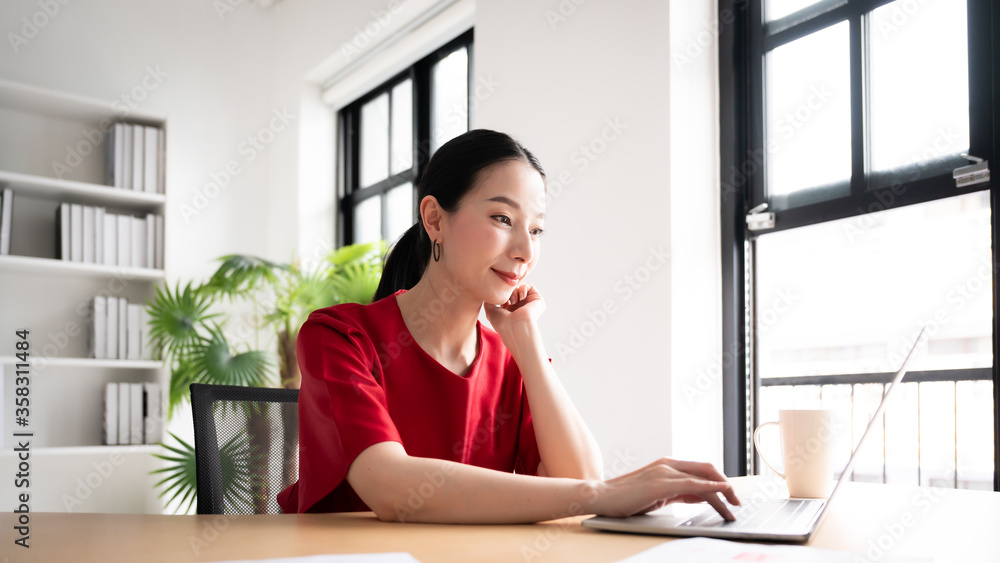 Work from home concept, Portrait of beautiful young asian woman working on laptop in workplace Work from home concept, Portrait of beautiful young asian woman working on laptop in workplace