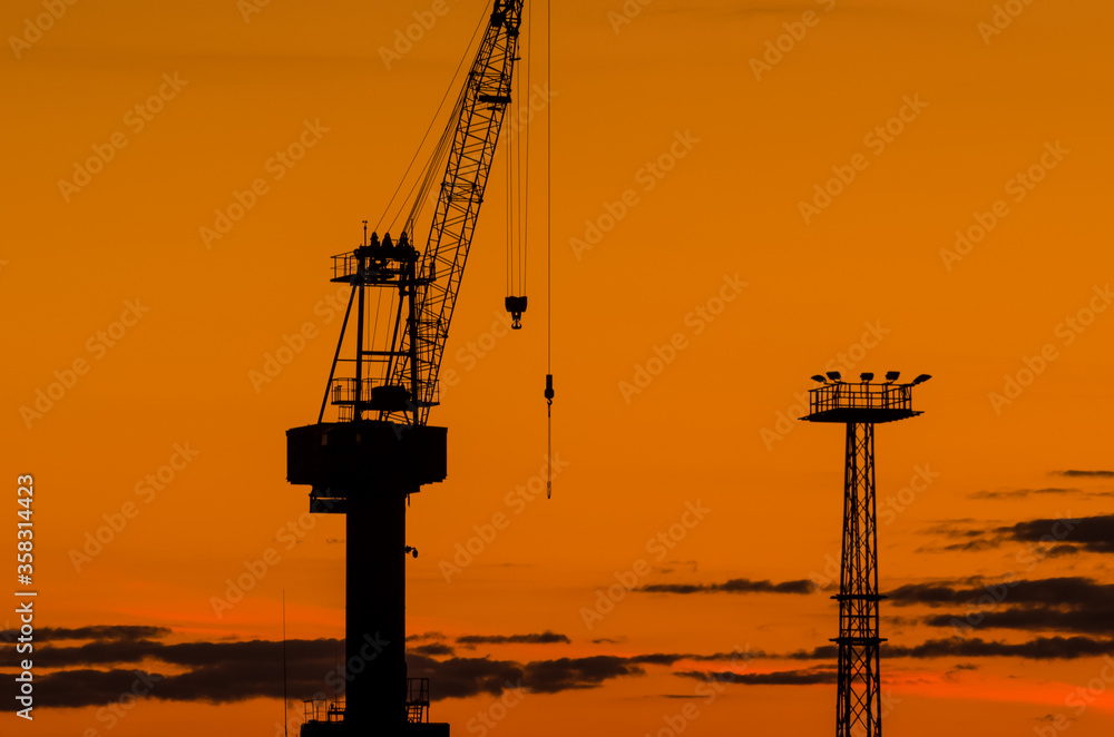 PORT CRANE - A device for moving heavy loads in the port and shipyard at sunrise