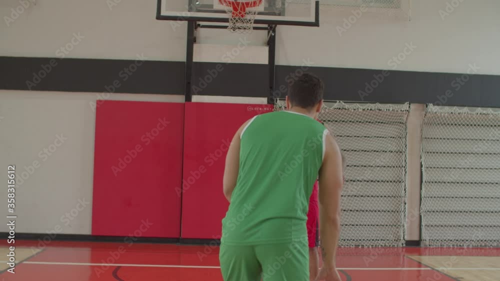 Athletic african american basketball player making step back jump shot ...