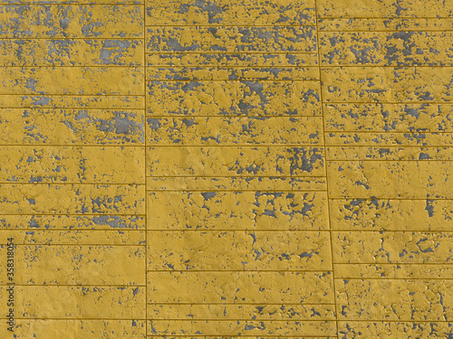 Weathered and scratched yellow paint on a concrete wall background. © ersoy